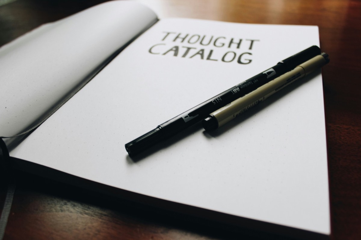 Notebook and pens, representing NLP and reflective coaching
