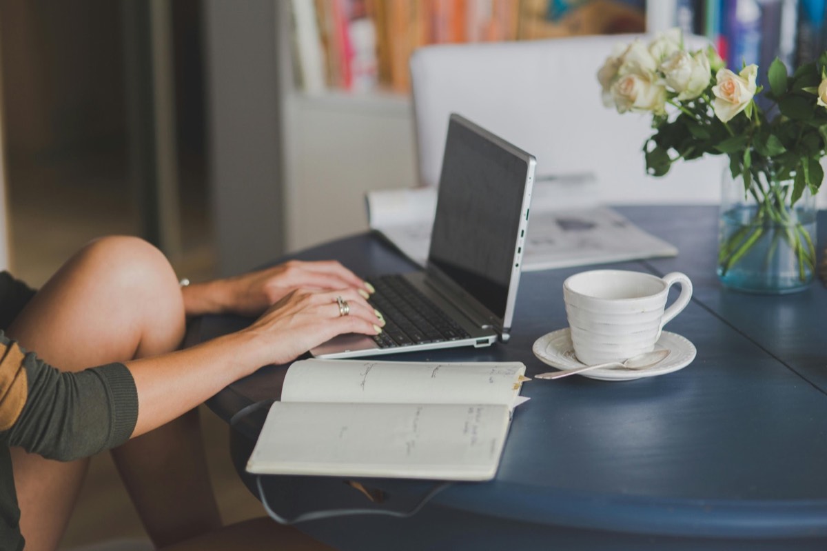 Laptop and coffee on a desk, representing Sylvia Xydas, events orchestrator